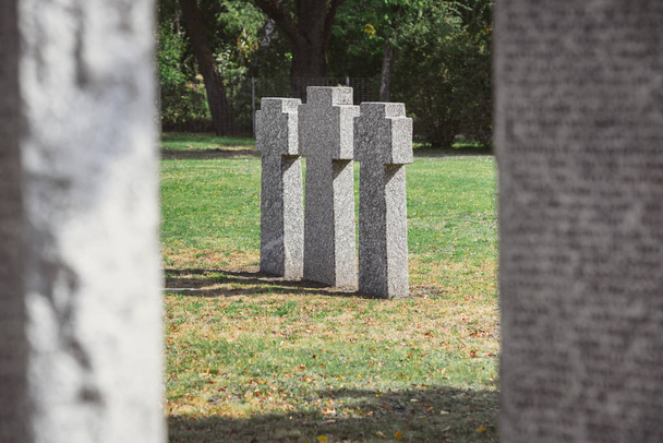 selective focus of identical gravestones placed in row at graveyard - Photo, Image