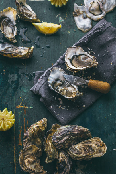 Fresh oyster on wooden board - 写真・画像