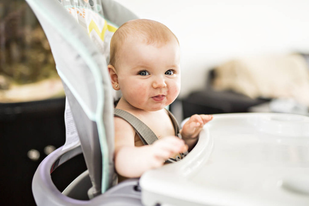 準備を食べるための高い椅子に座っている女の赤ちゃん - 写真・画像