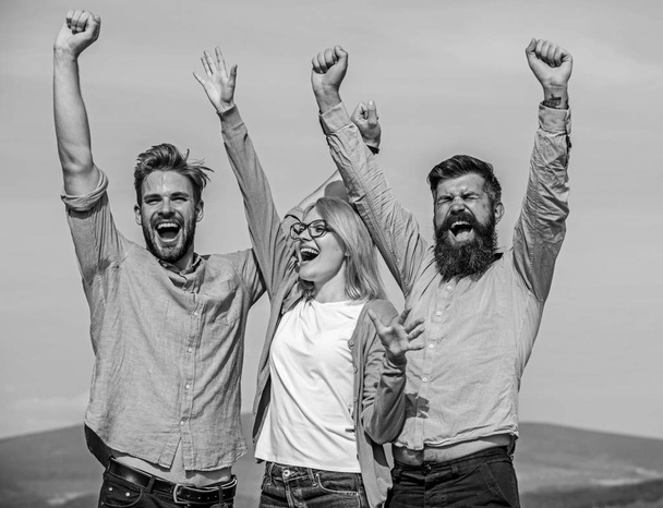 Employees enjoy feeling of freedom. Freedom concept. Company three happy colleagues office workers enjoy freedom, sky background. Men with beard in formal wear and blonde in eyeglasses finished work - Foto, Bild