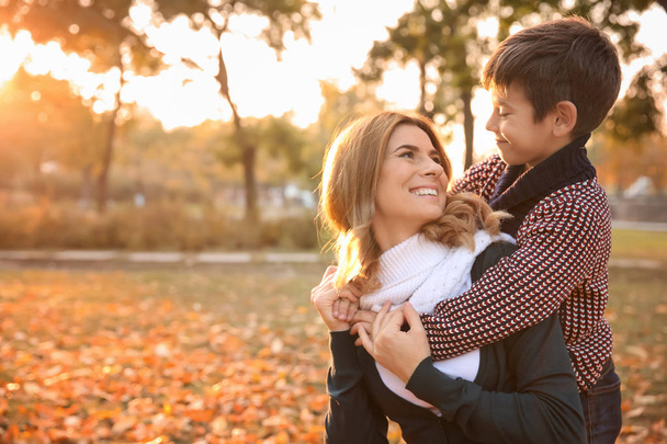 Happy mother and son in autumn park - Photo, Image