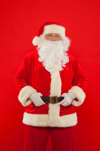 Photo of happy Santa Claus in eyeglasses looking at camera - Фото, изображение