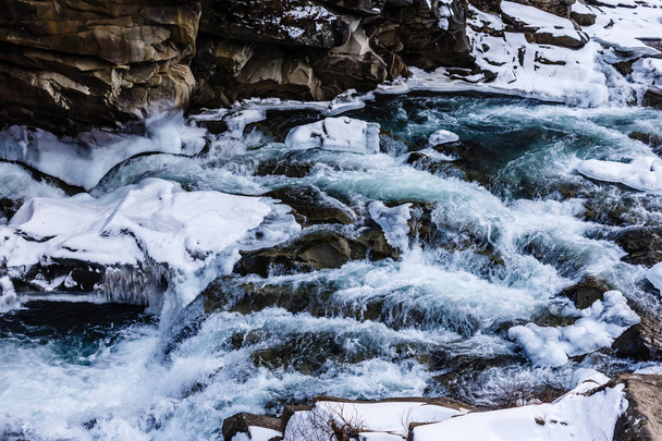Scenic view of wild rocky river in frozen woods - Zdjęcie, obraz