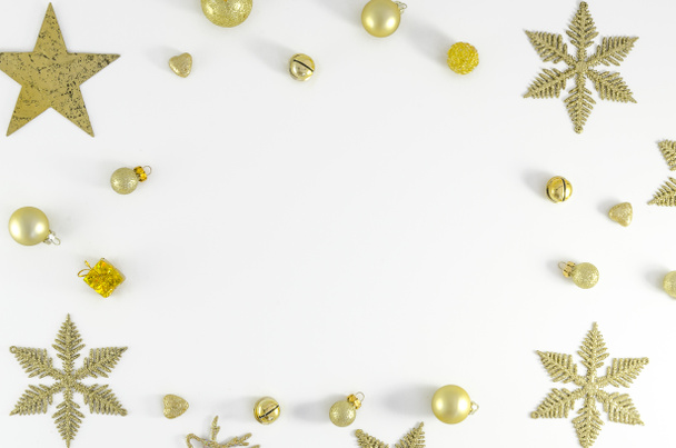 christmas or new year frame composition. christmas decorations in gold colors on white background with empty copy space for text. holiday and celebration concept for postcard or invitation. top view - Photo, image