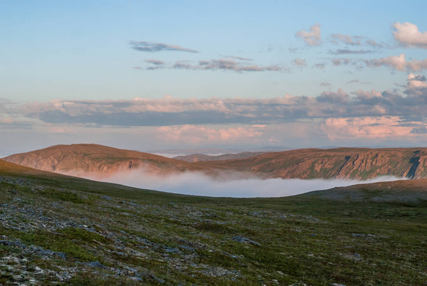 Fog on the hills at sunset, Soroya island, Norway - Photo, image