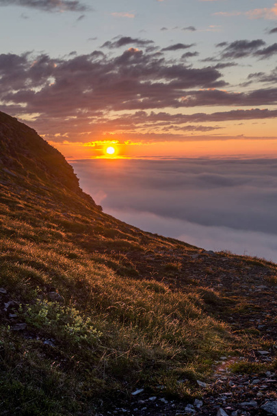Ηλιοβασίλεμα σε μια ομίχλη πάνω στα βράχια του νησιού Soroya, Νορβηγία - Φωτογραφία, εικόνα