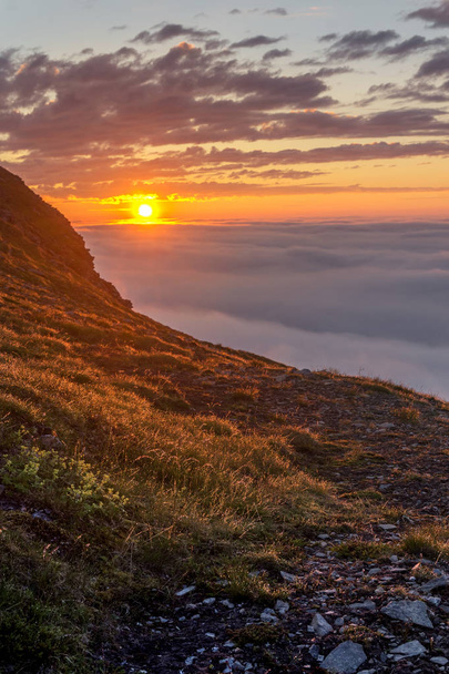 Sunset in the fog on the rocks of Soroya Island, Norway - Fotoğraf, Görsel