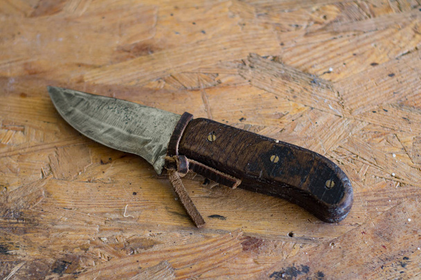 handmade knife on wooden table in workshop - Fotó, kép