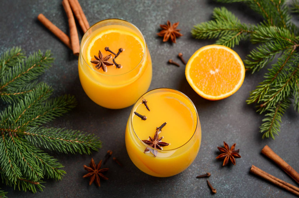 Fall Winter Cocktail Hot Spicy Orange Punch with Spices. Holiday Concept Decorated with Fir Branches and Spices. - Photo, Image