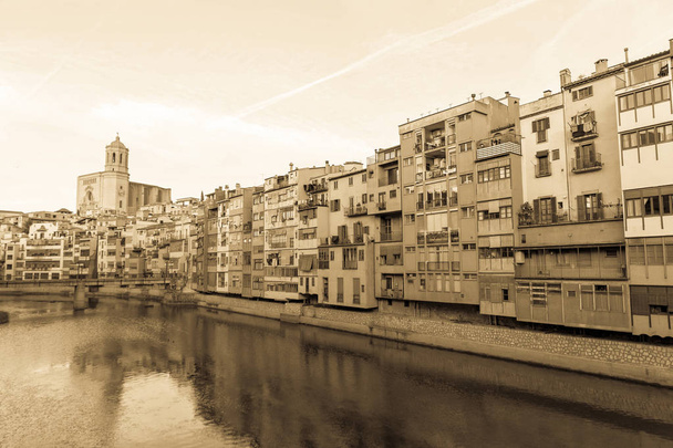 Onyar river crossing the downtown of Girona with bell tower of Basilica of Sant Feliu in background. Gerona, Costa Brava, Catalonia, Spain. - Photo, Image
