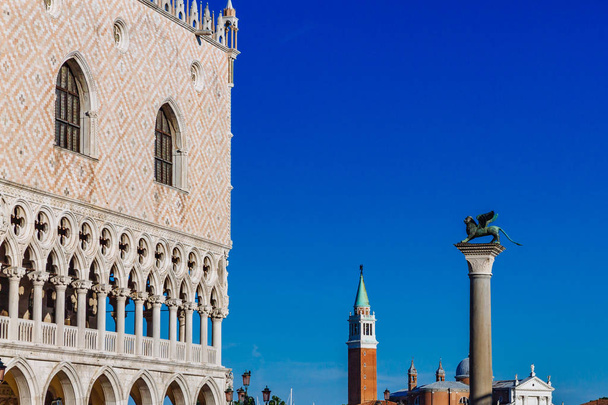 View of exterior of Doge's Palace, San Giorgio Maggiore church and bell tower, and Saint Mark column, in Venice, Italy - Photo, Image