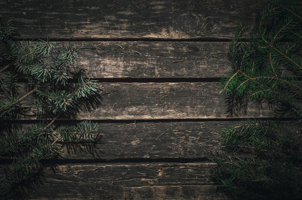 Christmas background. Fir tree branches on the wooden table background with copy space. Top view. - Fotoğraf, Görsel