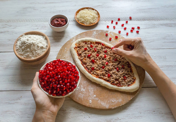 Handmade pizza with tuna stuffing and pomegranate seeds. - Photo, Image