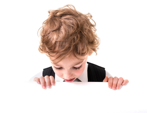 Little boy is peeking from blank sign - Fotografie, Obrázek