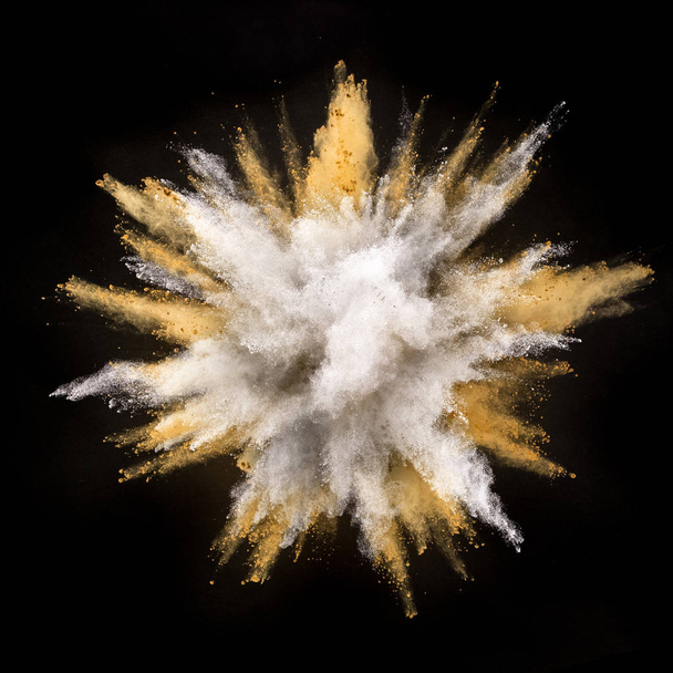 Silver and gold powder explosion on black background. Freeze motion. - Фото, изображение