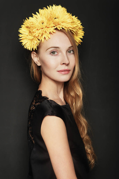 Young Woman with Wreath of Yellow Flowers on Black Background. Natural Beauty Concept. - Φωτογραφία, εικόνα