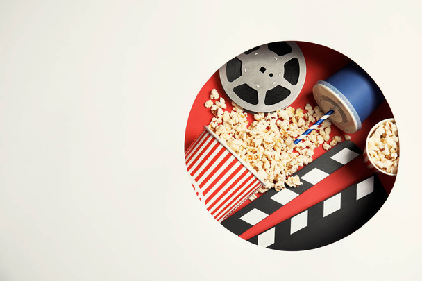 Composition with popcorn, cinema reel and space for text on color background, top view - Фото, зображення