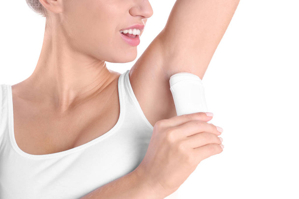 Young woman using deodorant on white background, closeup - Foto, Imagem