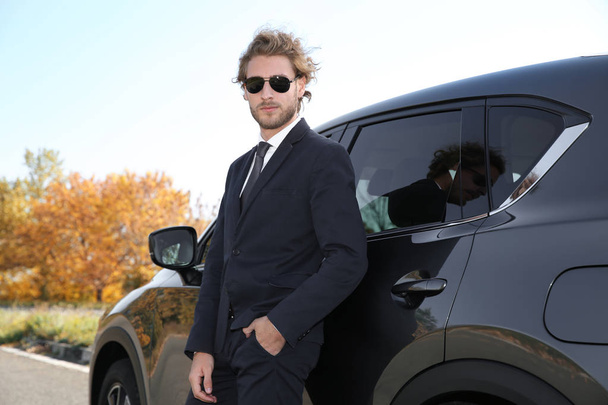 Young businessman near modern car on sunny day, outdoors - Foto, immagini