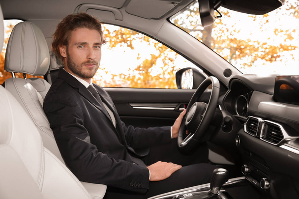 Young handsome man in driver's seat of modern car - Fotoğraf, Görsel