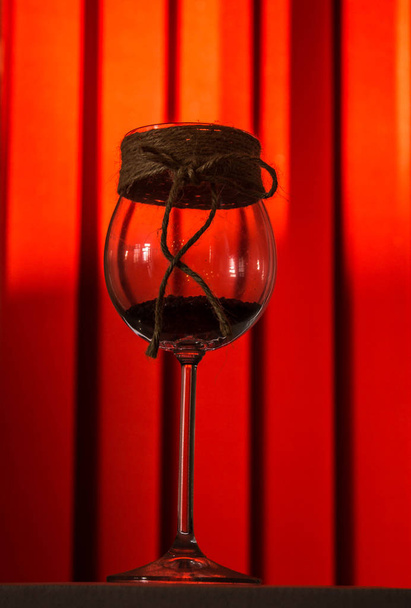 Beautiful glass with candles on a red background. - Fotó, kép