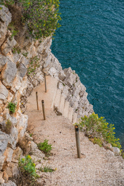 Steep, scary and dangerous rocky stairs down to the Croatian coast in Dubrovnik, Croatia - Valokuva, kuva