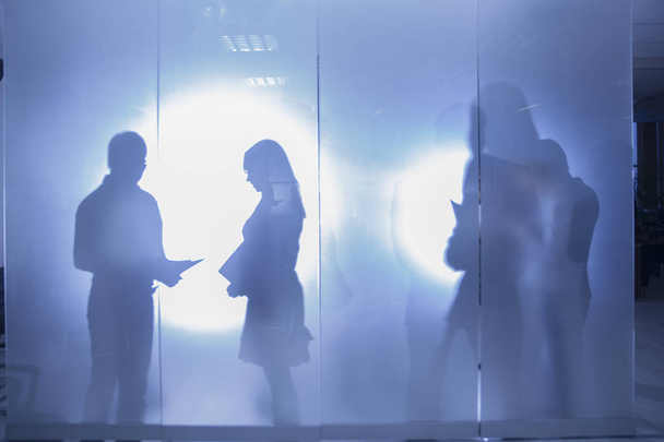 Silhouettes of business people talking about work in office  - Foto, Imagen