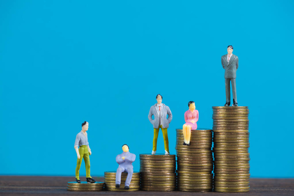 Figure miniature businessman or small people investor and office worker secretary standing on coin stack, for money and financial business success concept idea. - Foto, Bild