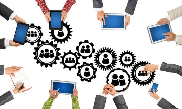Group of people with devices in hands working together as symbol of networking and communication - Foto, Imagem