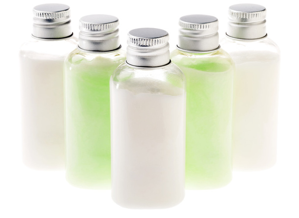 Изолированные бутылки зеленого и белого лосьонов
 - Фото, изображение