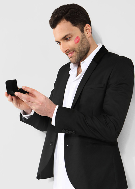 Attractive man looking at black box with cufflinks - Foto, afbeelding