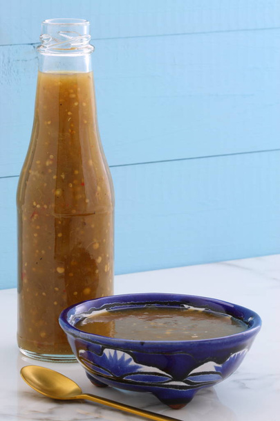 Artisan mexican tomatillo sauce on retro vintage carrara marble setting, with a spicey mild hot flavor perfect for all your Mexican, tex-mex recipes and sides. - Photo, Image