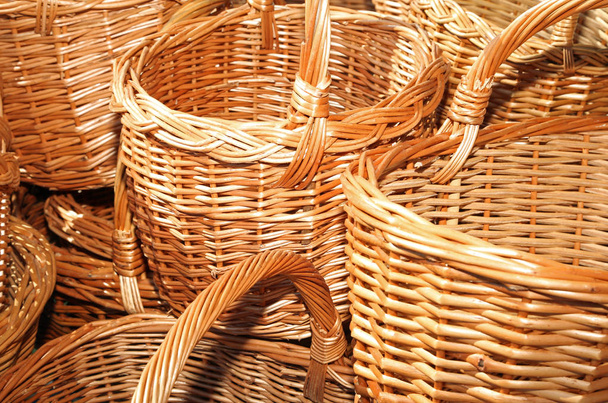 sale of many wicker baskets in the craft store - Photo, Image