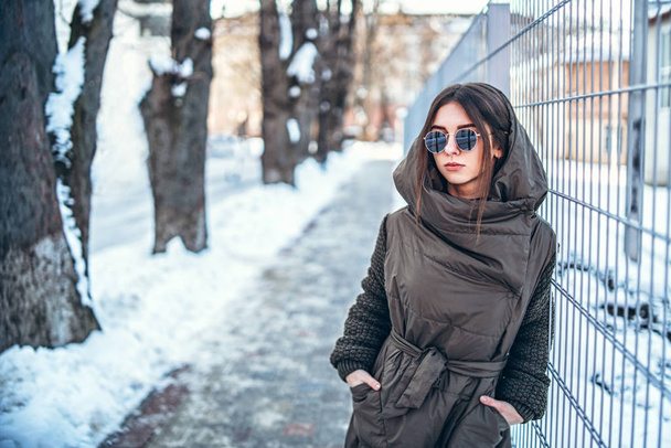 Pretty girl walking outdoor on the street, winter time - Фото, изображение
