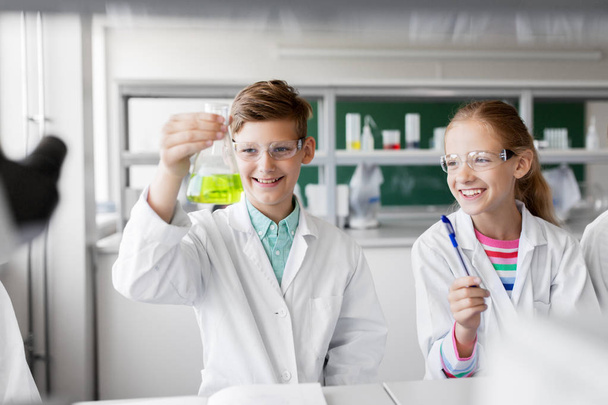 kids with test tubes studying chemistry at school - Photo, image
