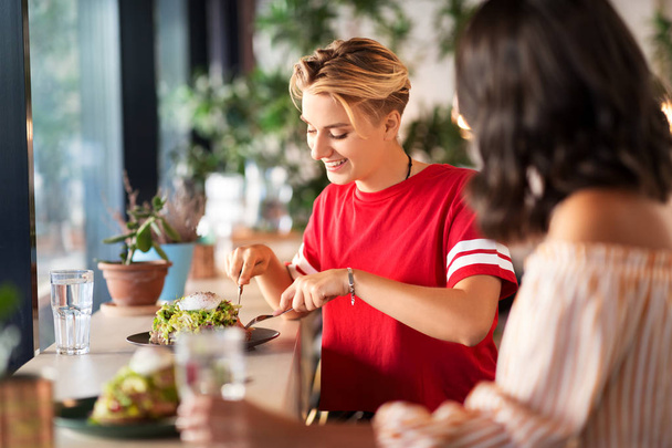 female friends eating at restaurant - Фото, зображення