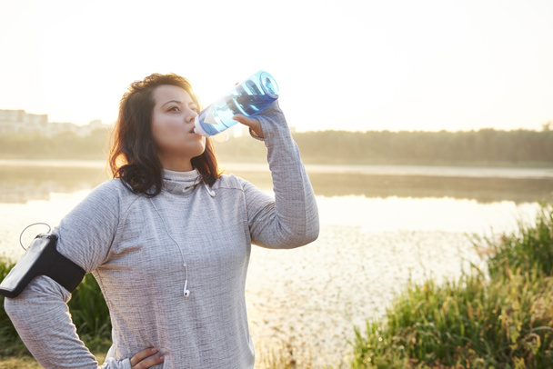 Vrouw drinkwater na harde training - Foto, afbeelding