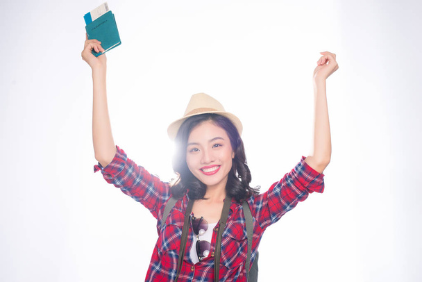 Joven hermosa mujer asiática en sombrero con pasaporte y billete de avión sobre fondo blanco
 - Foto, imagen