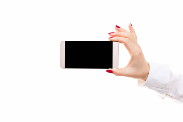 mobile smart phone in female hand on a white background - Фото, изображение