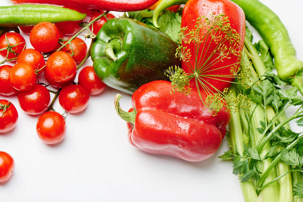 Peppers, cherry tomatoes, eggplants and dill on a white background with a copy space. Fresh multicolored vegetables - Foto, imagen