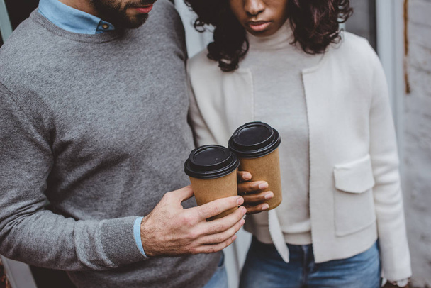 cropped view of multiethnic casual business couple having coffee - Photo, Image