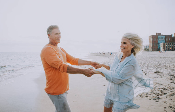 Boldog idősebb pár tölteni az időt a strandon. Fogalmak, a szerelemről, a szolgálati idő és az emberek - Fotó, kép