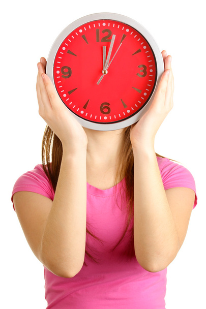 Girl holding clock over face isolated on white - Foto, imagen
