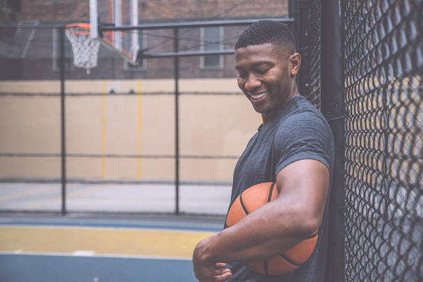 Basketball player training on a court in New york city - Fotó, kép
