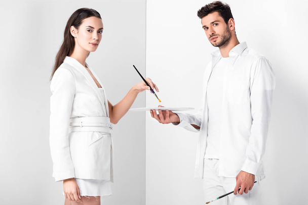 adult artists in total white with drawing equipment - 写真・画像