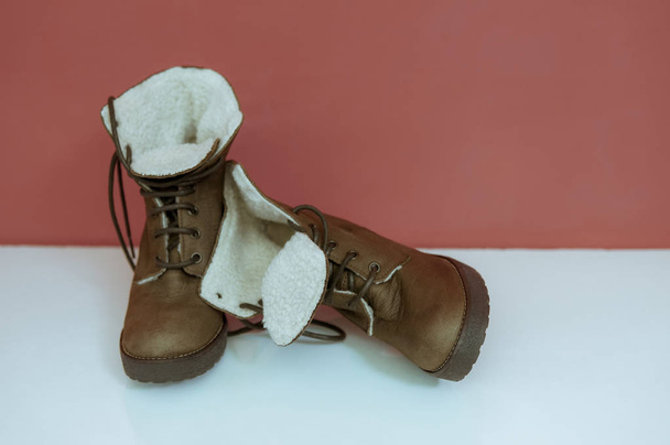 Cute winter or autumn high boots over dark background, toned image - Foto, afbeelding