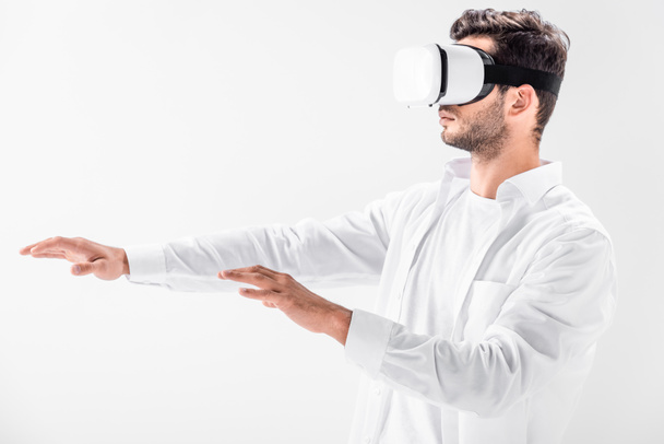 close up of adult man in virtual reality headset gesturing isolated on white - Foto, afbeelding