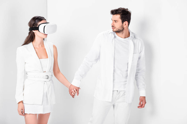 adult man walking with woman in virtual reality headset - Foto, Imagen