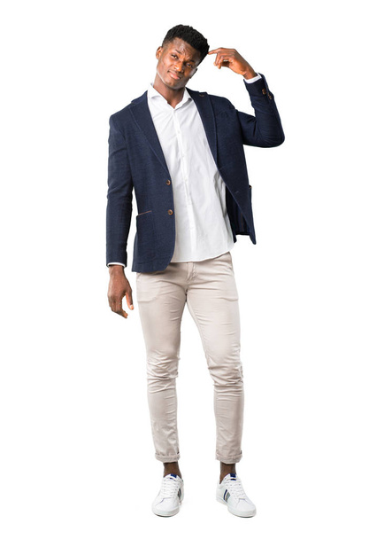 Corpo inteiro de belo homem afro-americano vestindo um casaco de pé e pensando em uma ideia sobre fundo branco
 - Foto, Imagem