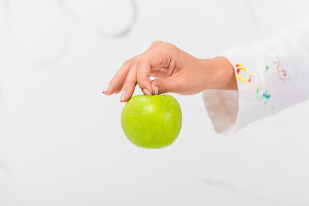 close up of female hand holding green fresh apple - Foto, afbeelding